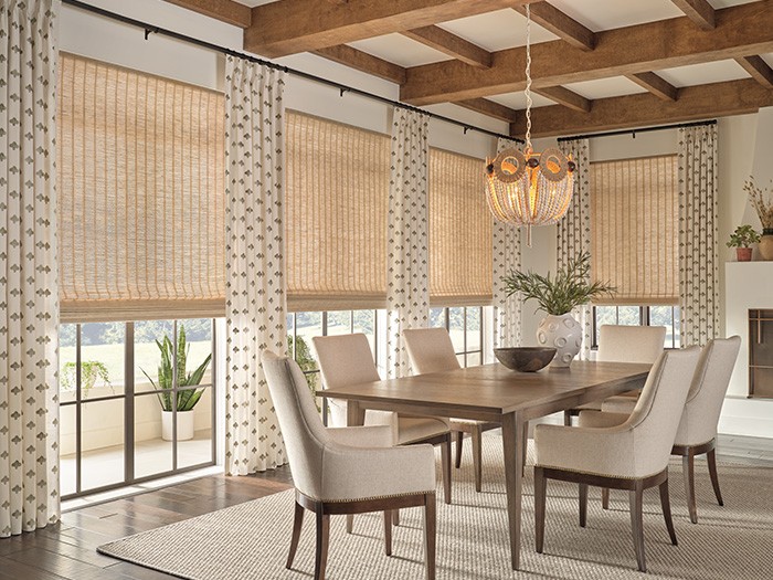 Provenance® Woven Wood Shades highlight large windows in a dining room.